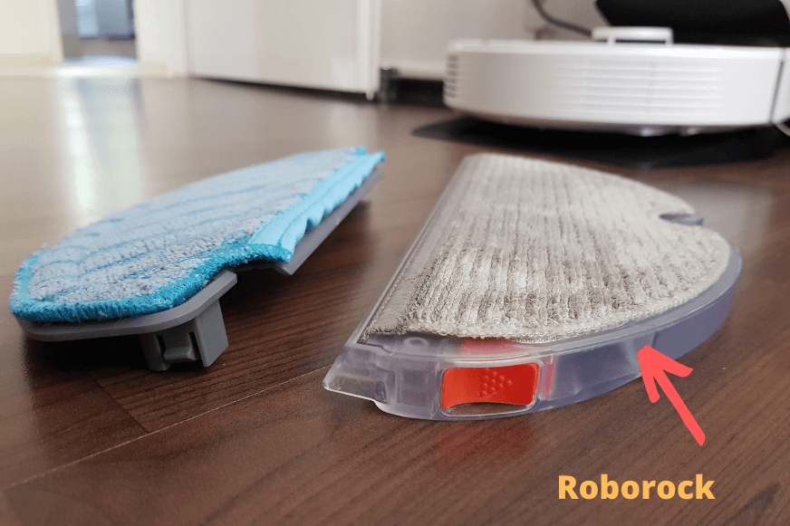 The Roborock Q7 Max+ mop lies on the floor next to a mop from a competitor product.
